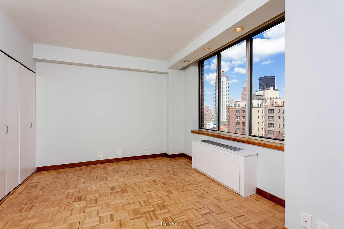 420 East 58th Street, Unit 17B Manhattan, NY 10022 - Photo 4 of 12 a view of an empty room with a window
