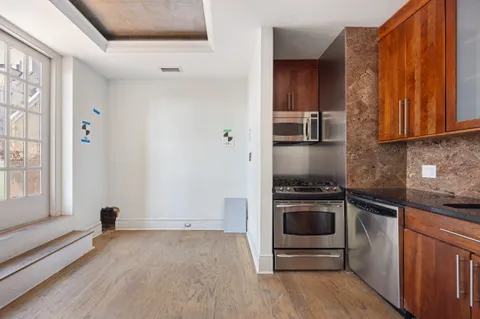 a kitchen with a stove and a refrigerator