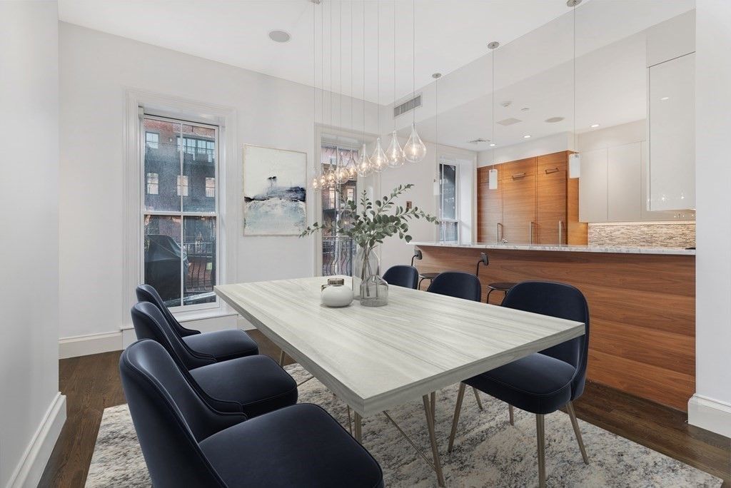 a view of a dining room with furniture and wooden floor