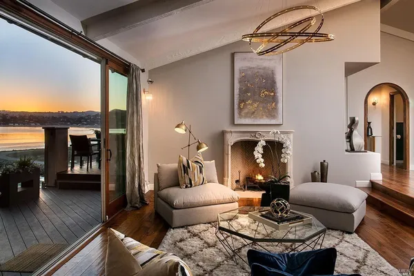 a living room with furniture a fireplace and a table