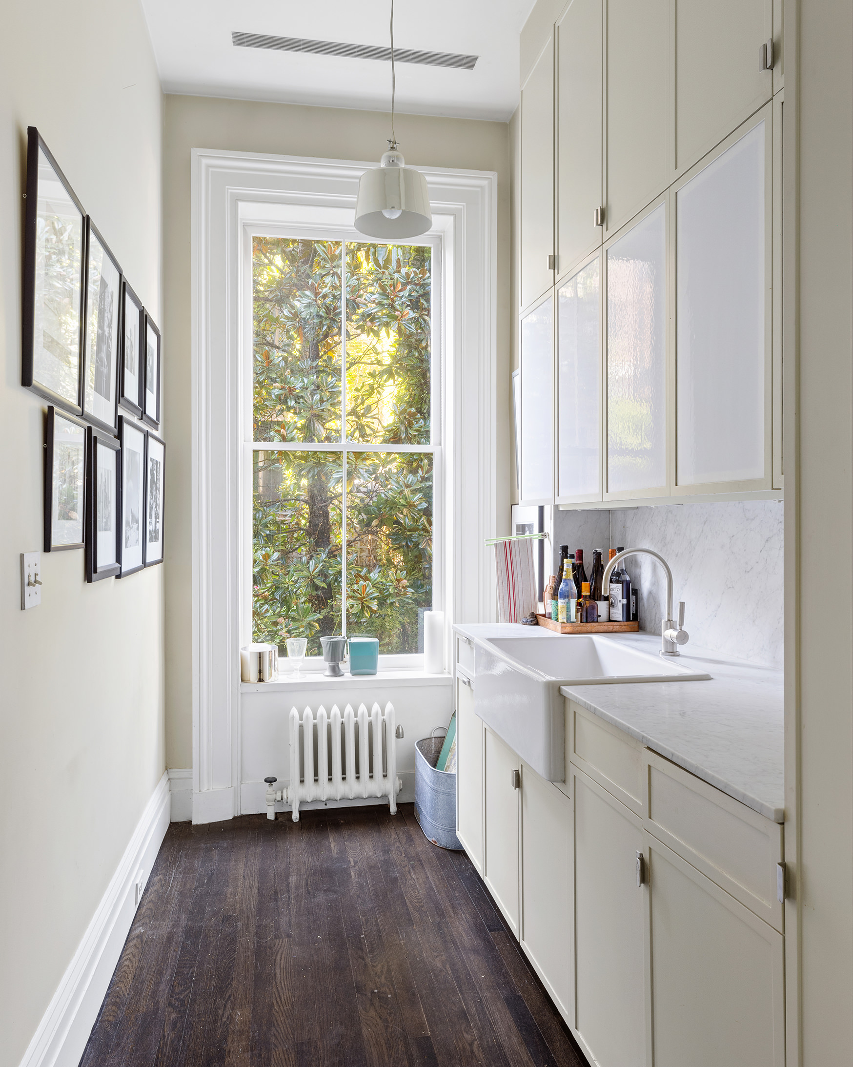 25 Perry Street Manhattan, NY 10014 - Photo 10 of 32 a kitchen with a window a sink and a refrigerator