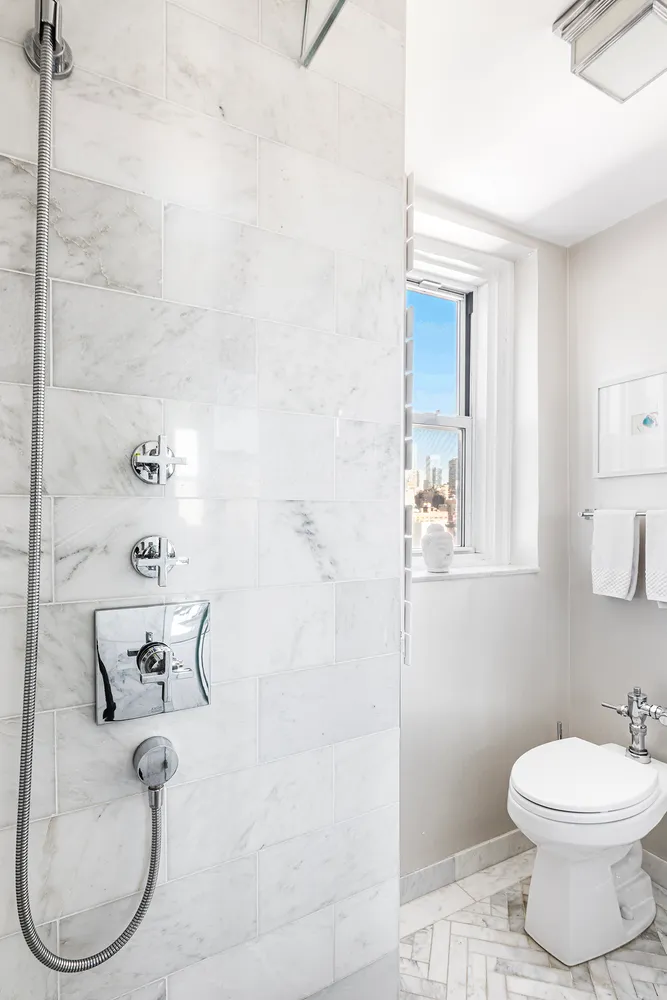 a bathroom with a toilet and shower