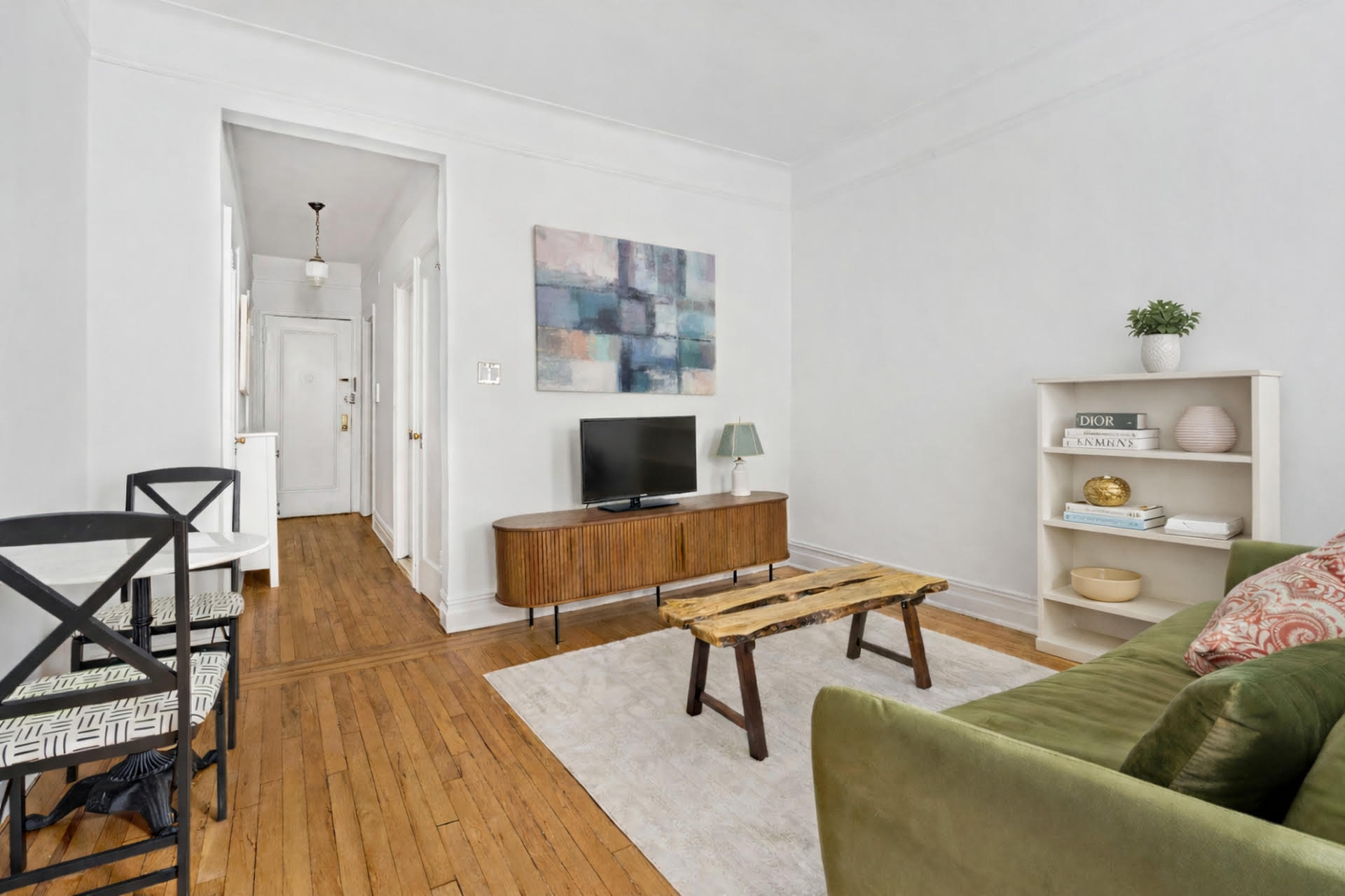 121 East 88th Street, Unit 3A Manhattan, NY 10128 - Photo 2 of 7 a living room with furniture and a wooden floor