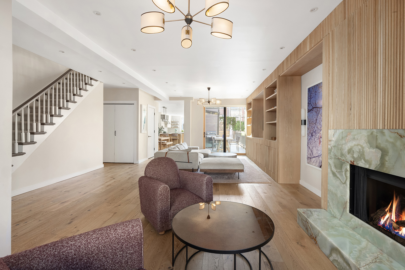 683 Leonard Street Brooklyn, NY 11222 - Photo 2 of 25 a living room with furniture a fireplace and a chandelier