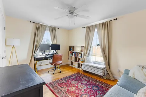a living room with a couch next to a large window