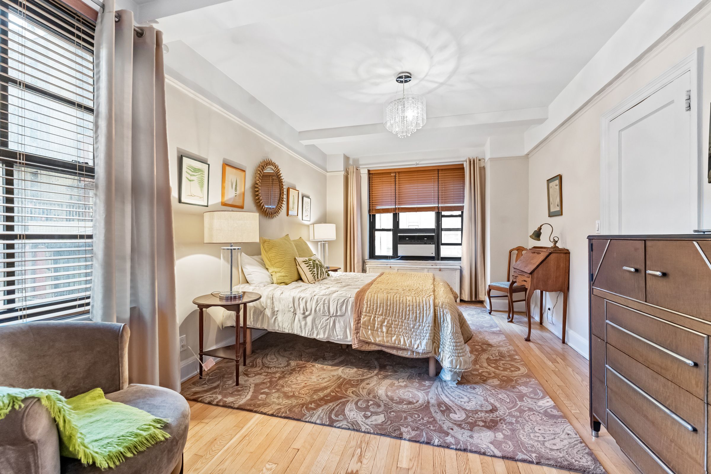 a living room with a bed furniture and a window