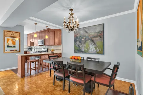 a view of a dining room with furniture and chandelier
