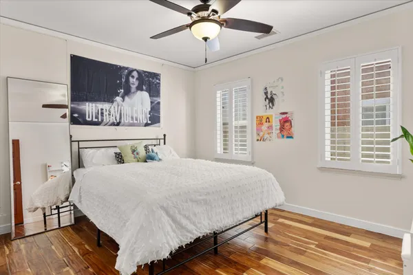 a bedroom with a bed and a potted plant