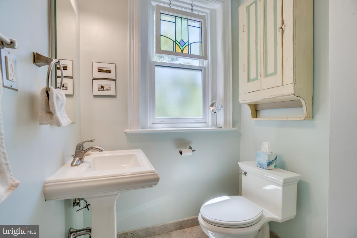 2415 20th Street Northwest, Unit 38 Washington, DC 20009 - Photo 19 of 30 a bathroom with a sink a toilet and a mirror