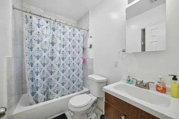 a white toilet sitting next to a bathroom sink