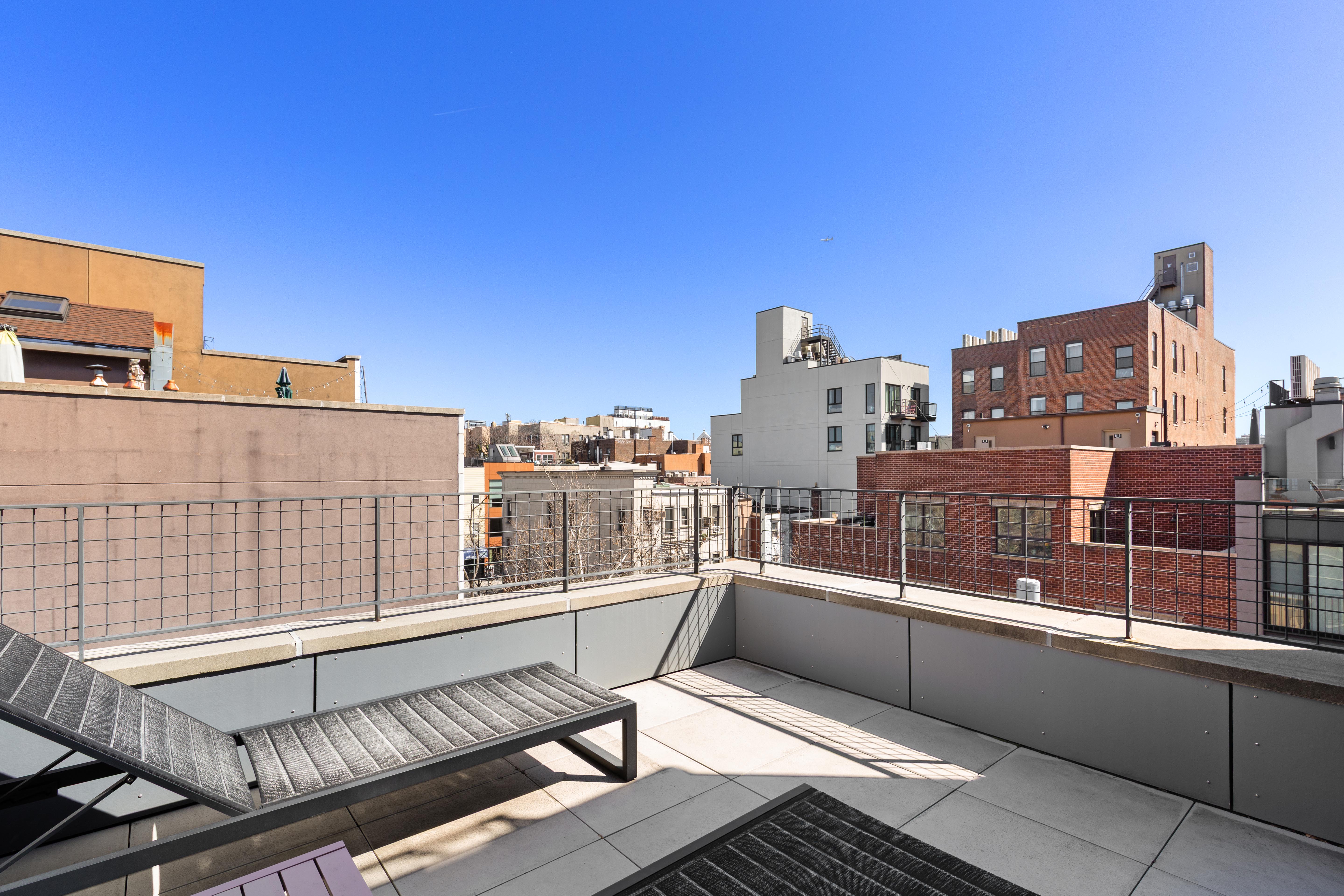 33 Conselyea Street, Unit PH Brooklyn, NY 11211 - Photo 7 of 16 a view of a balcony with two chairs