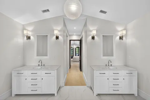 a bathroom with a double vanity sink double vanity and mirror