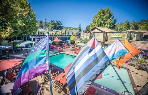 a bedroom with a large bed and a wooden floor