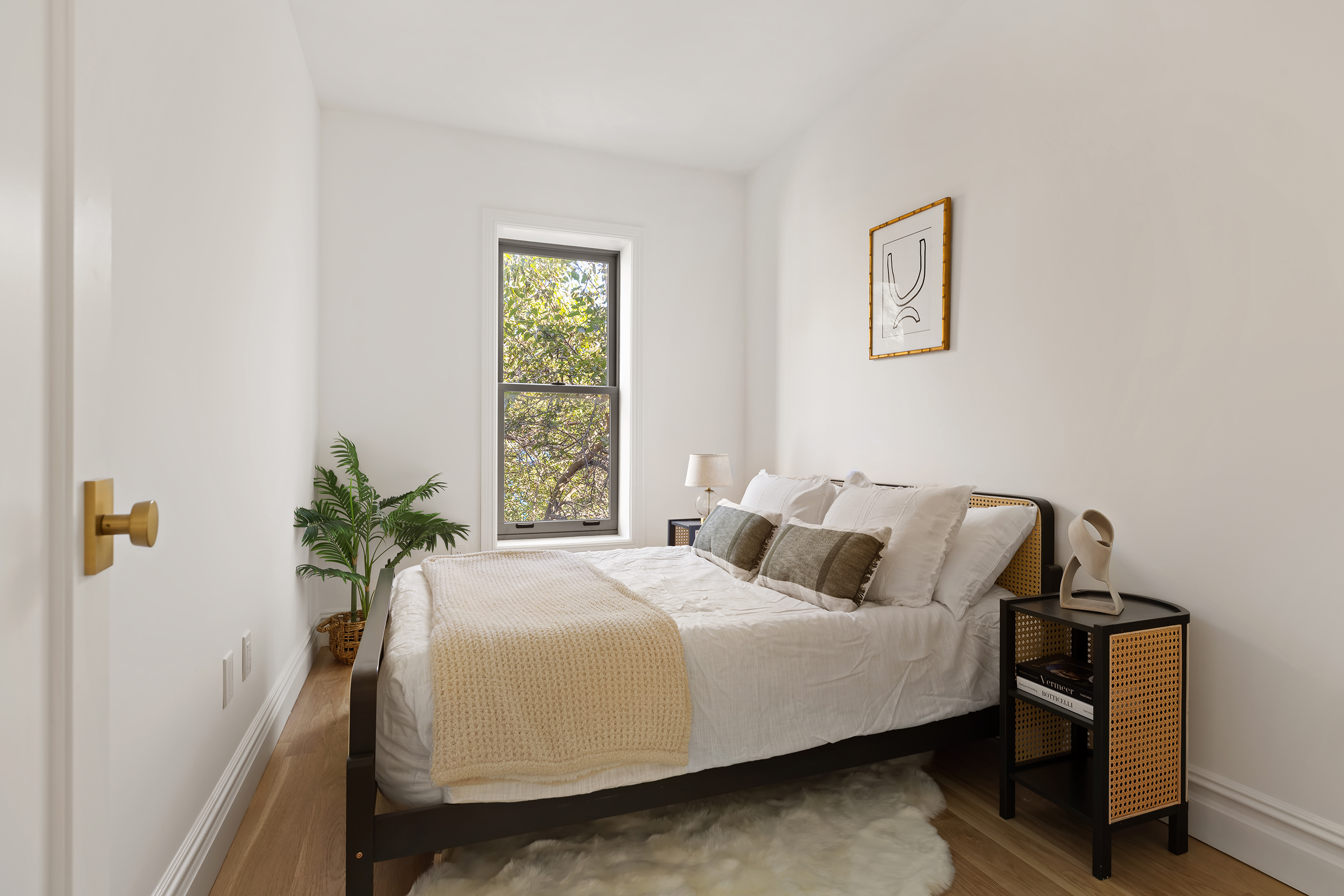 1433 Dean Street Brooklyn, NY 11213 - Photo 14 of 18 a bedroom with a bed table and a window