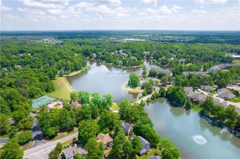 an aerial view of a houses with outdoor space and ocean view