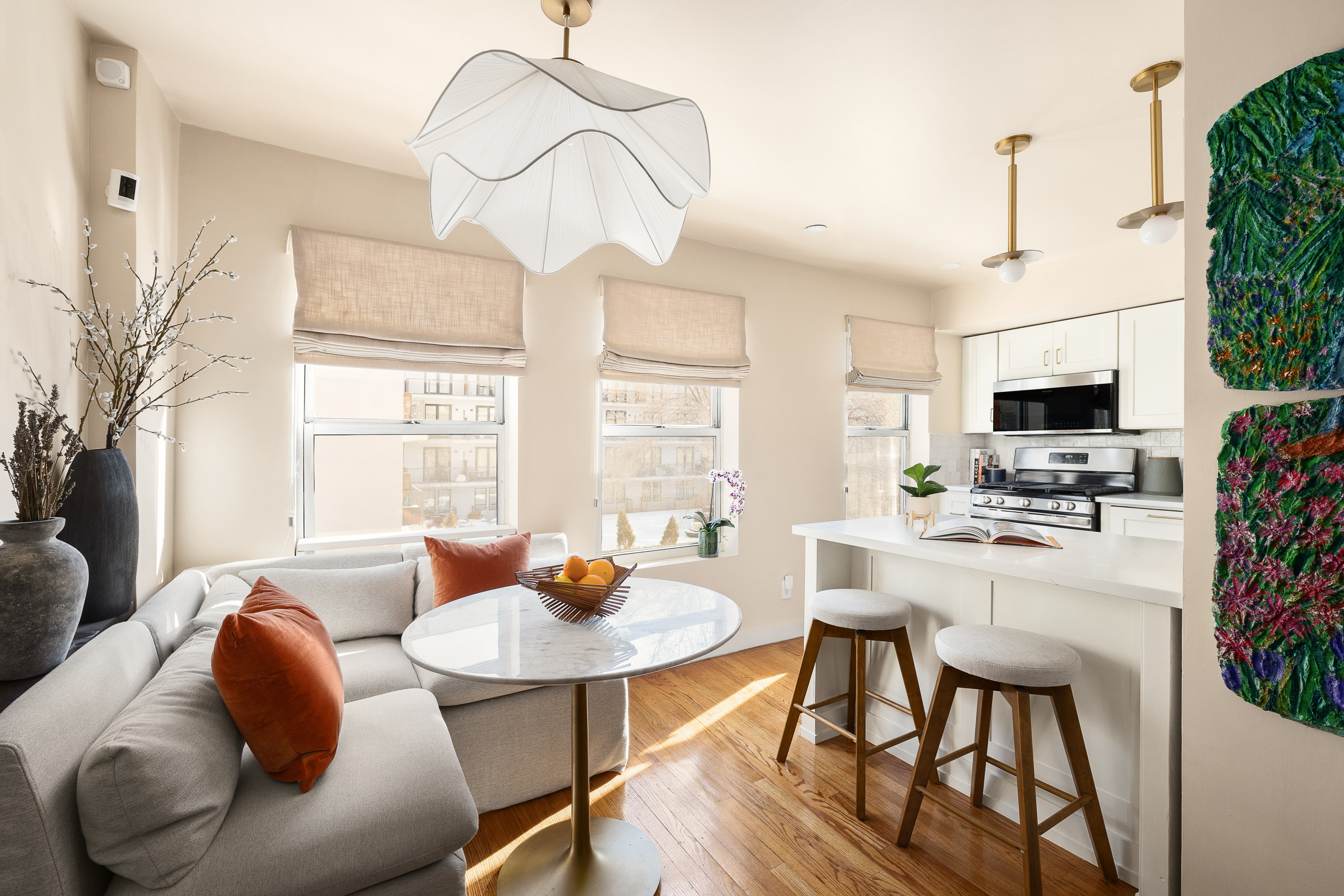 325 Grand Avenue, Unit A Brooklyn, NY 11238 - Photo 4 of 10 a kitchen with stainless steel appliances kitchen island granite countertop a dining table chairs and a refrigerator