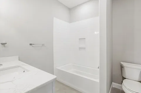 a bathroom with a bathtub and a toilet