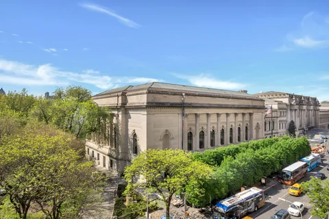 a view of a brick building next to a yard