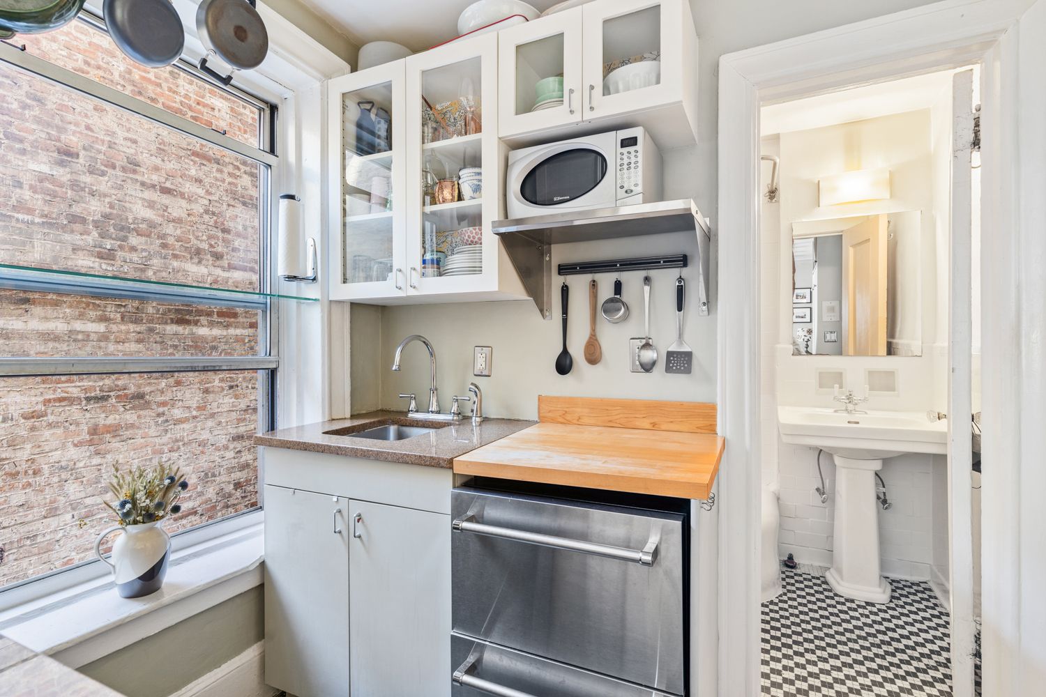 104 Bedford Street, Unit 4C Manhattan, NY 10014 - Photo 8 of 9 a kitchen with stainless steel appliances granite countertop a sink and cabinets