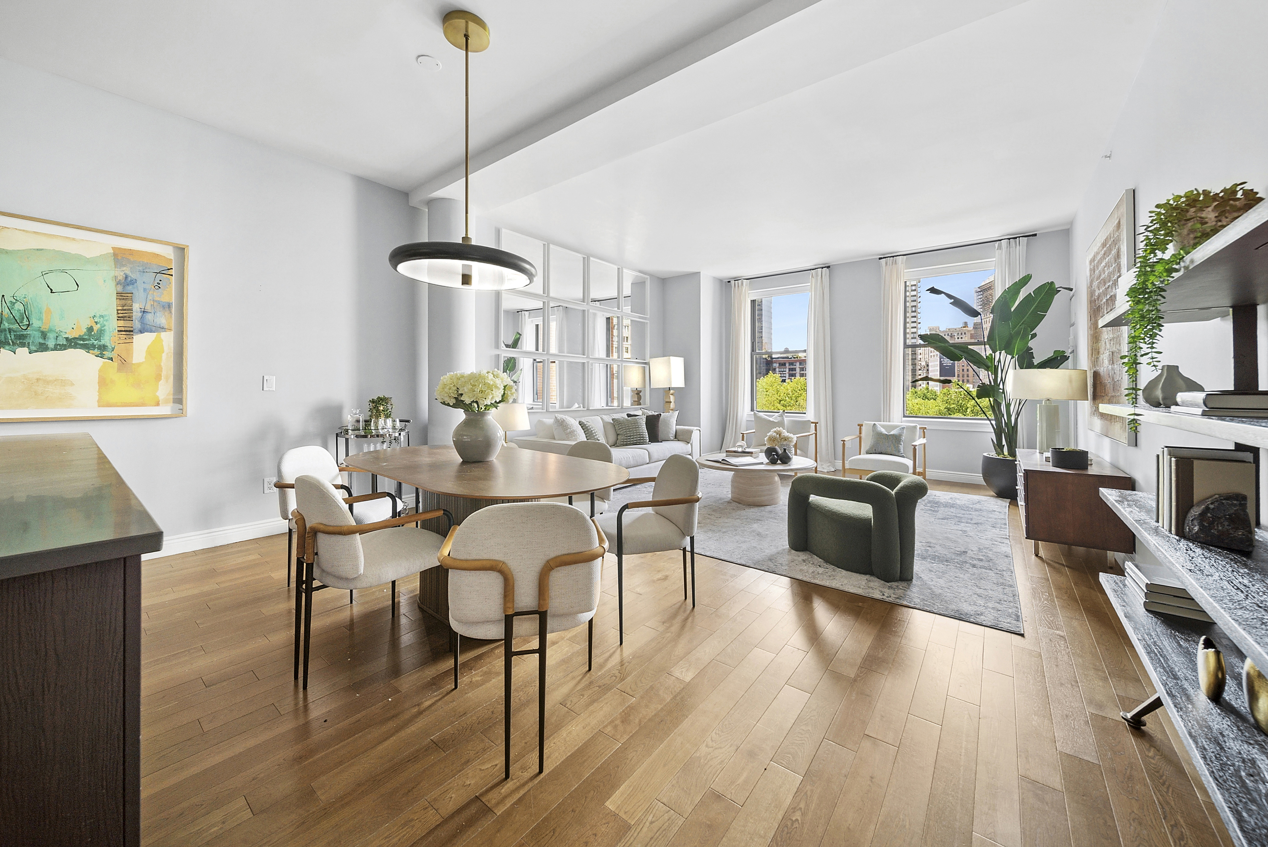 225 5th Avenue, Unit 7K Manhattan, NY 10010 - Photo 1 of 15 a view of a dining room with furniture a chandelier and wooden floor