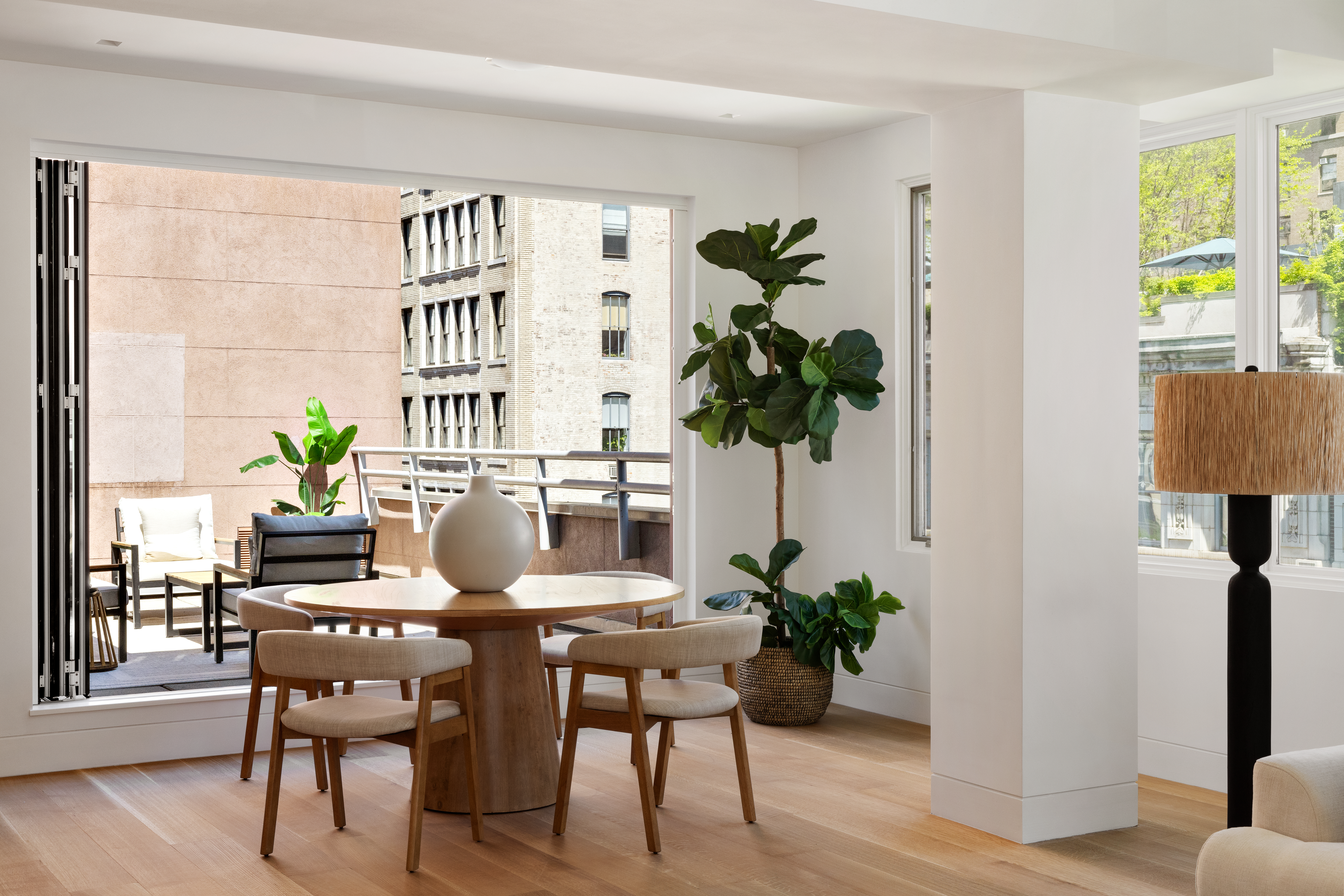 120 East 29th Street, Unit PHB Manhattan, NY 10016 - Photo 4 of 10 a dining room with furniture potted plants and wooden floor