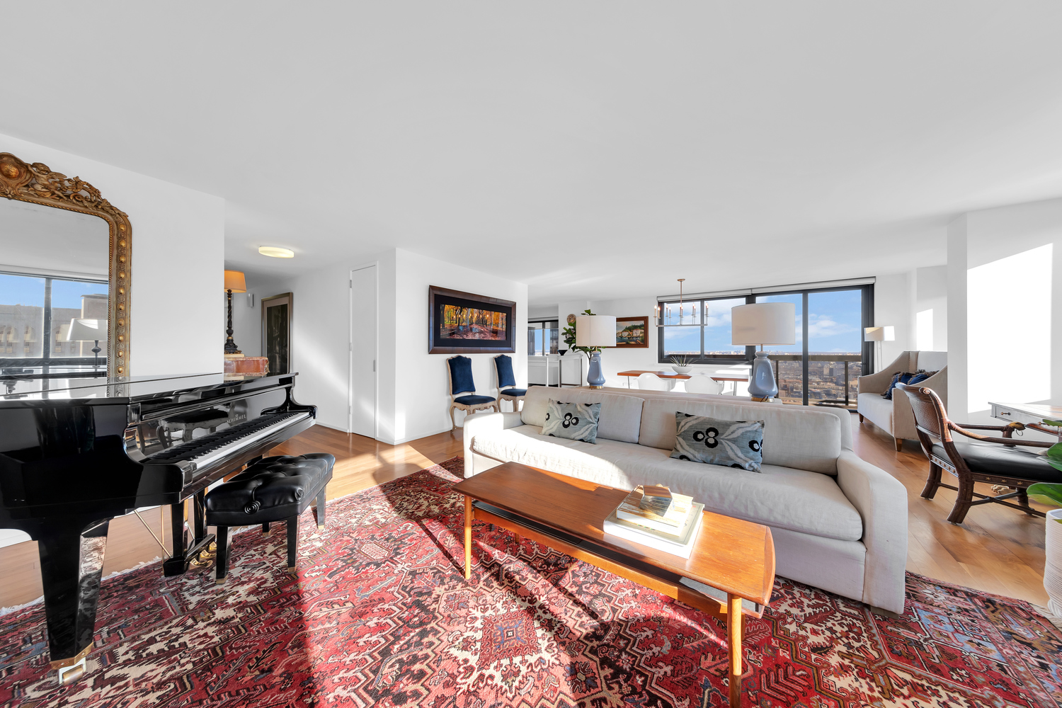 515 East 72nd Street, Unit 36B Manhattan, NY 10021 - Photo 2 of 36 a living room with furniture a rug and a piano