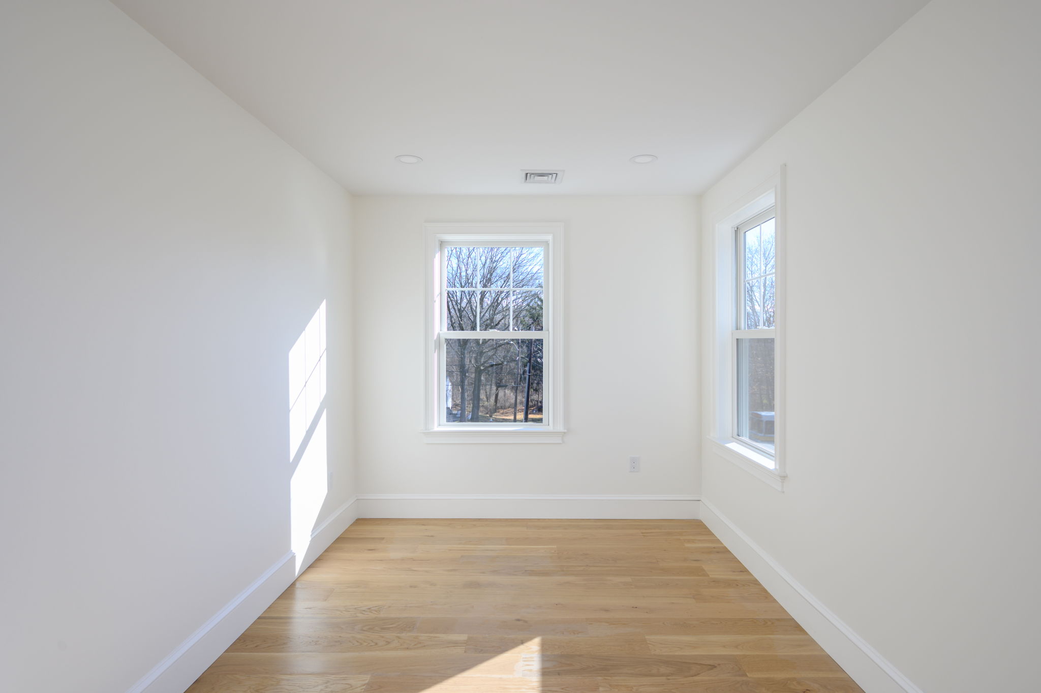 249 Central Avenue Milton, MA 02186 - Photo 32 of 61 an empty room with wooden floor and windows