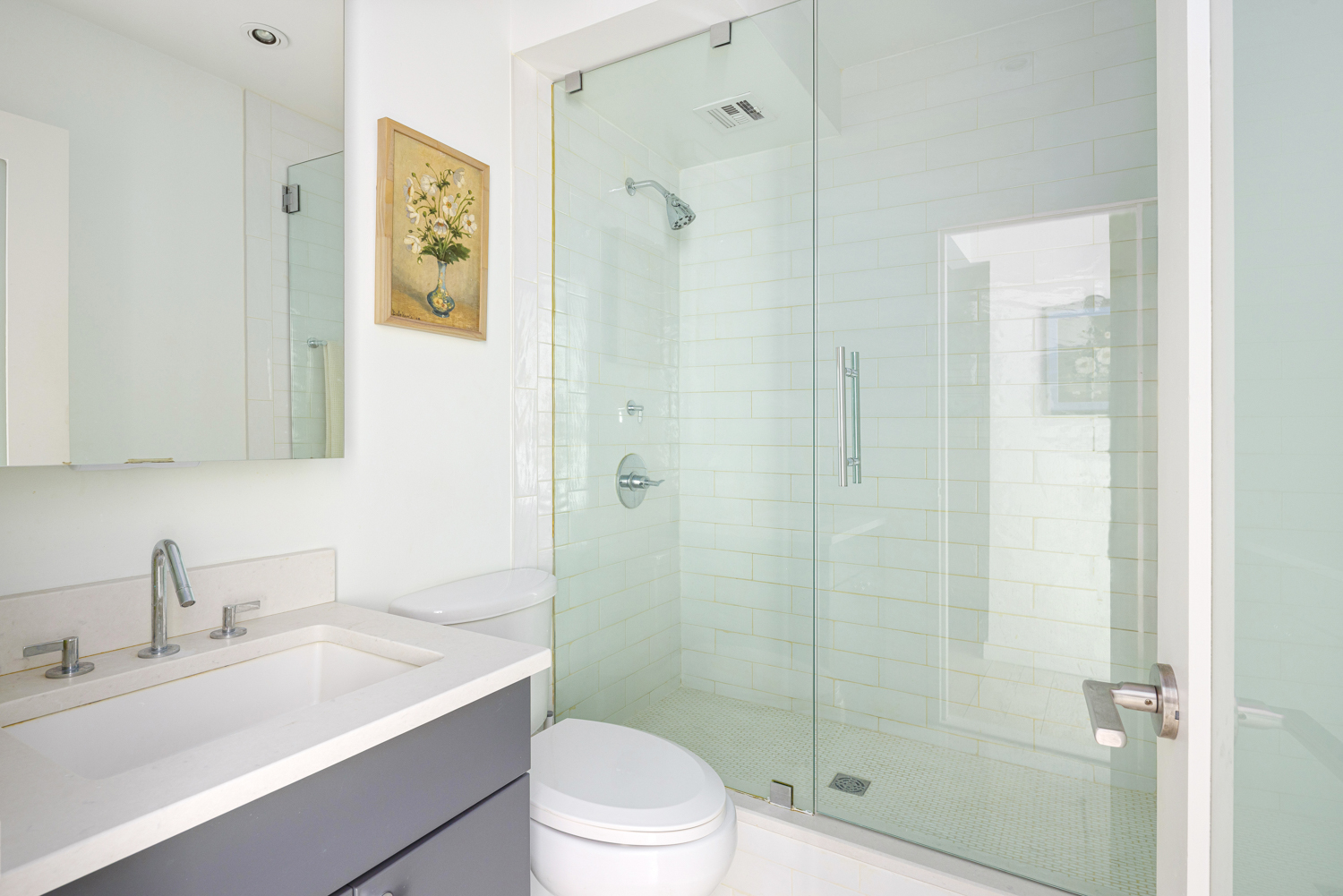77 Bleecker Street, Unit 1006W Manhattan, NY 10012 - Photo 4 of 8 a bathroom with a sink a toilet and shower