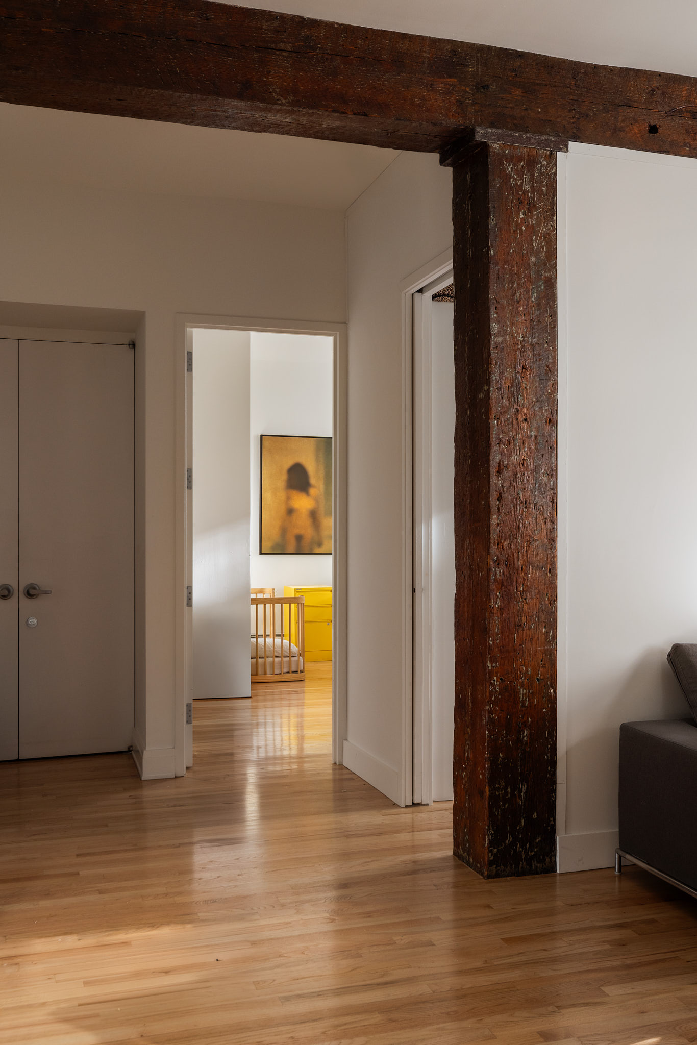 124 West 24th Street, Unit 4A Manhattan, NY 10011 - Photo 5 of 13 a view of a livingroom with wooden floor and a refrigerator
