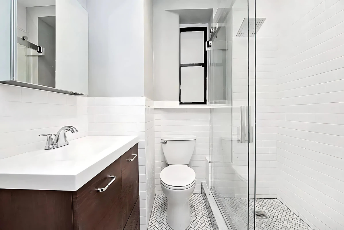 201 West 80th Street, Unit 4W Manhattan, NY 10024 - Photo 8 of 11 a bathroom with a sink a toilet and mirror