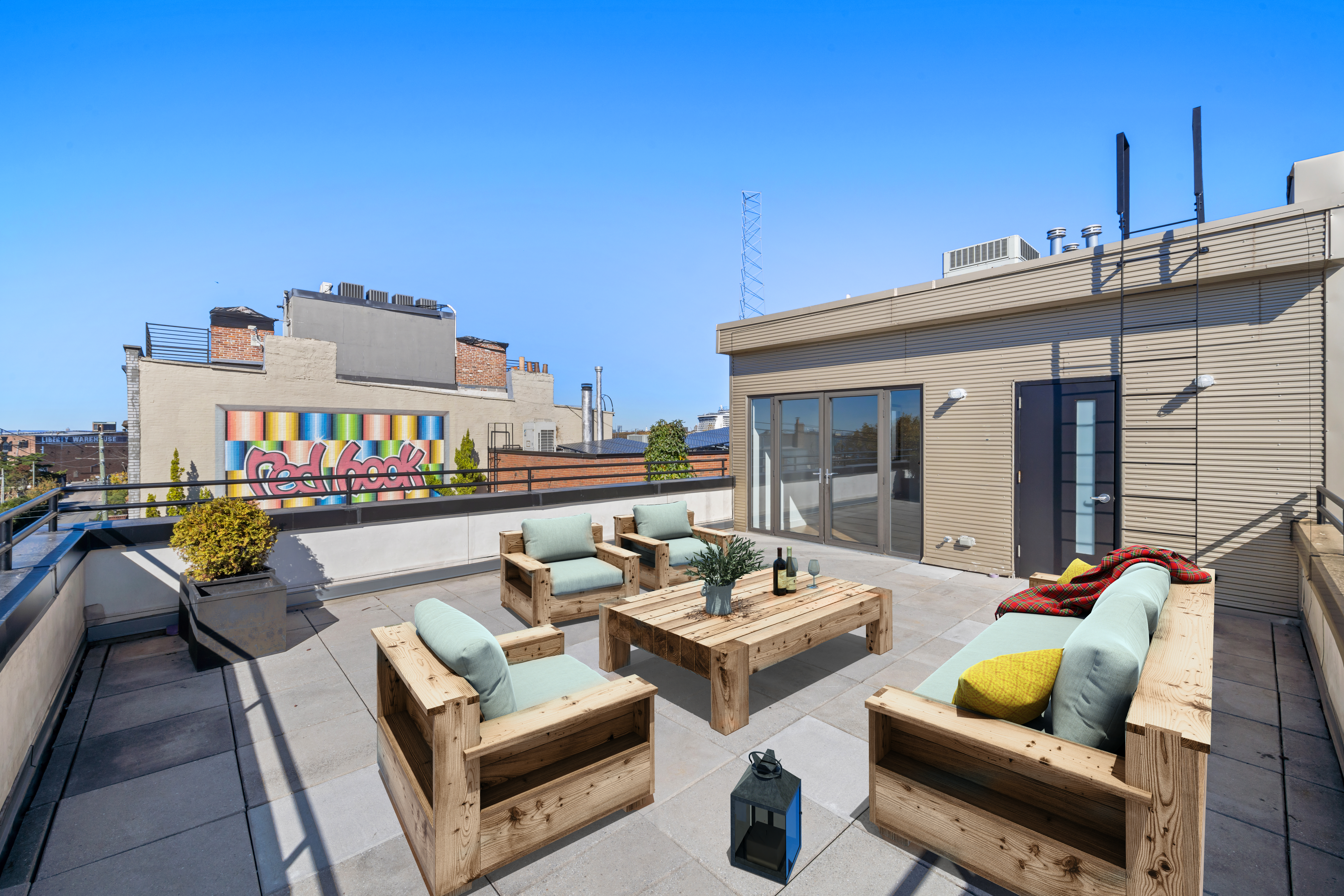 162 Beard Street Brooklyn, NY 11231 - Photo 5 of 20 a view of a patio with couches table and chairs with wooden floor