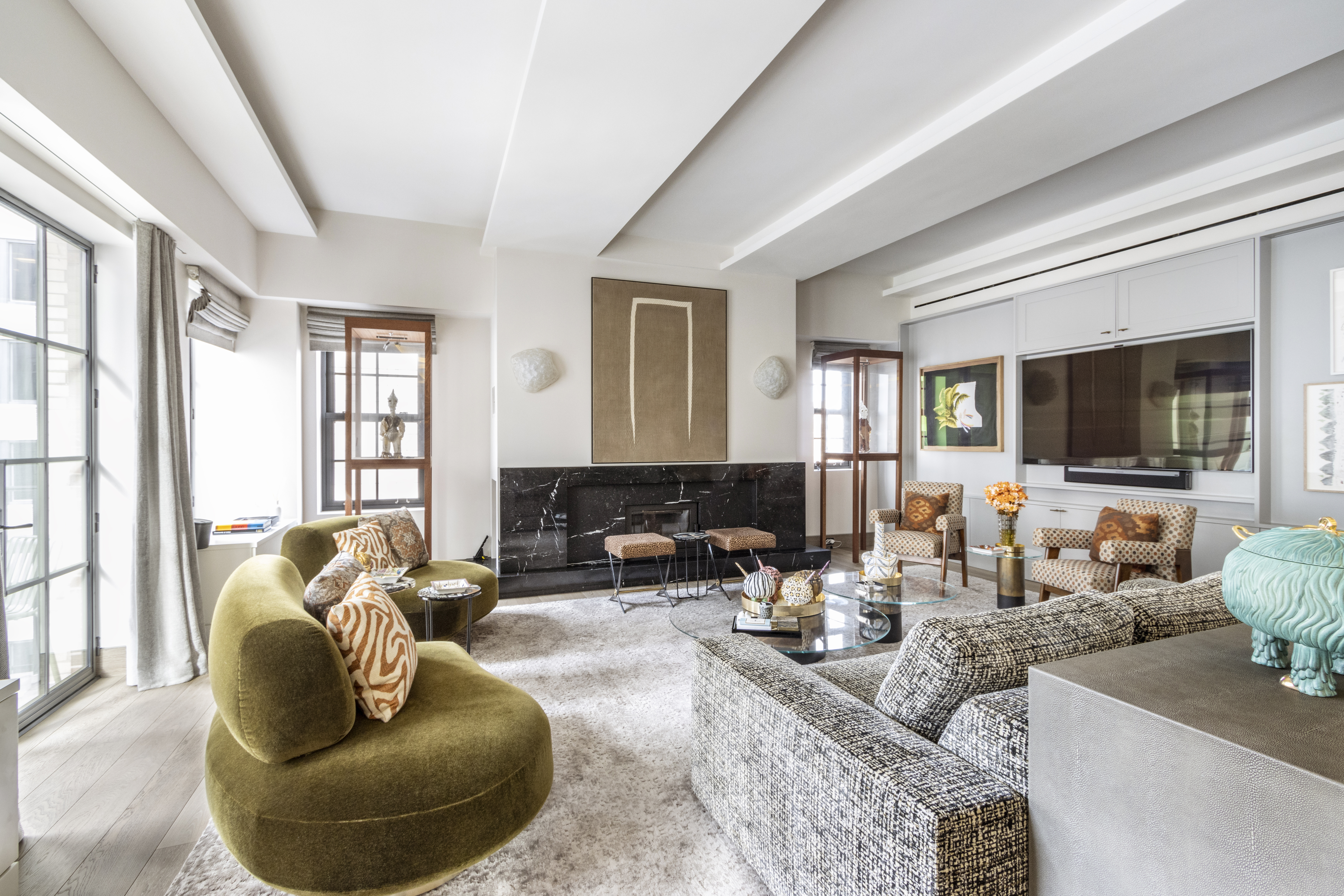 40 East 61st Street, Unit 18A Manhattan, NY 10065 - Photo 2 of 15 a living room with furniture and a flat screen tv