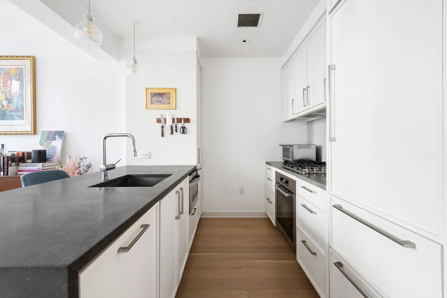 160 East 22nd Street, Unit 4D Manhattan, NY 10010 - Photo 2 of 15 a kitchen with granite countertop a sink and cabinets
