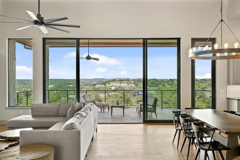 a living room with furniture and a floor to ceiling window