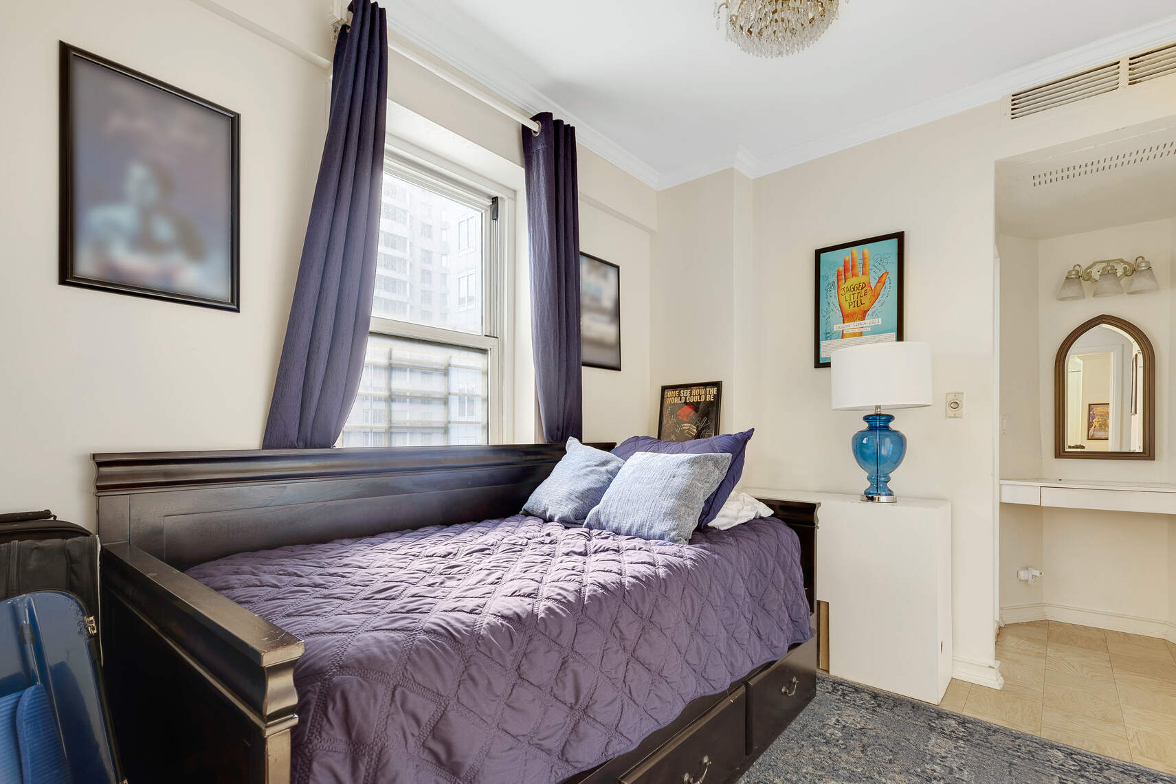 159 West 53rd Street, Unit 18A Manhattan, NY 10019 - Photo 5 of 8 a bedroom with bed and window