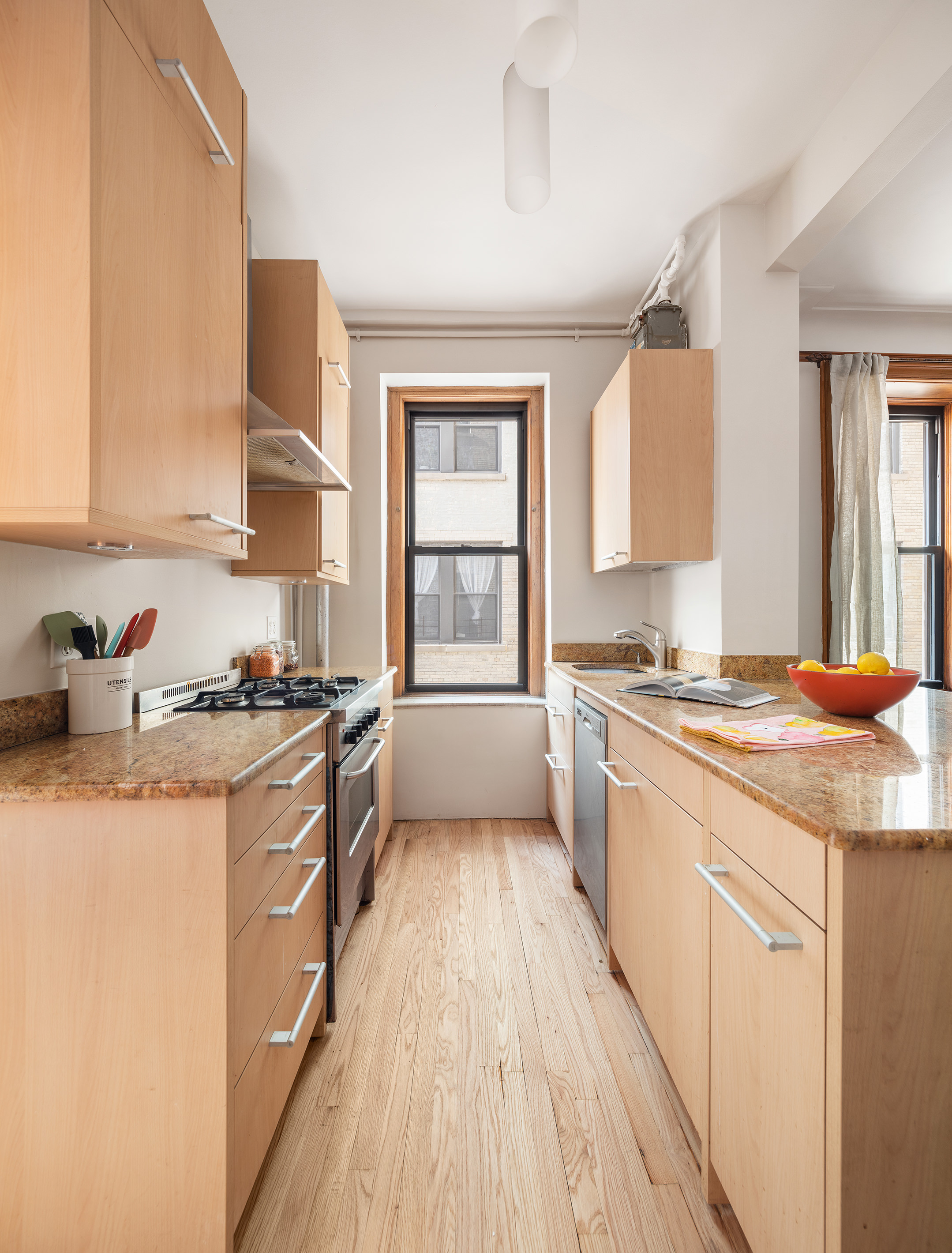 790 Riverside Drive, Unit 4C Manhattan, NY 10032 - Photo 7 of 11 a kitchen with a sink stove and cabinets