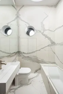 a bathroom with a sink a toilet and a shower