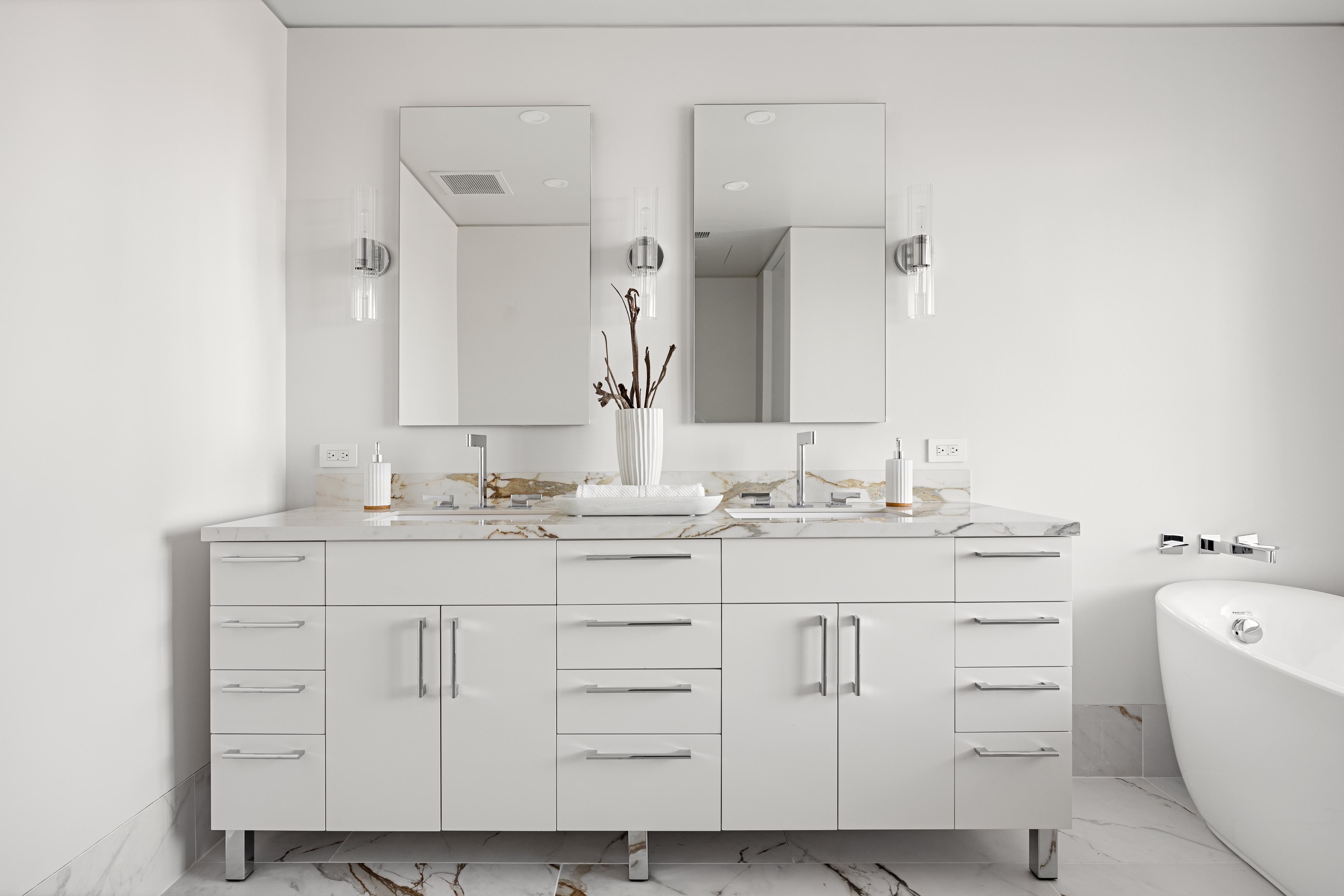 422 East 72nd Street, Unit 37AD Manhattan, NY 10021 - Photo 18 of 38 a bathroom with a sink and a mirror