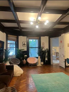 a living room with furniture and gym equipment