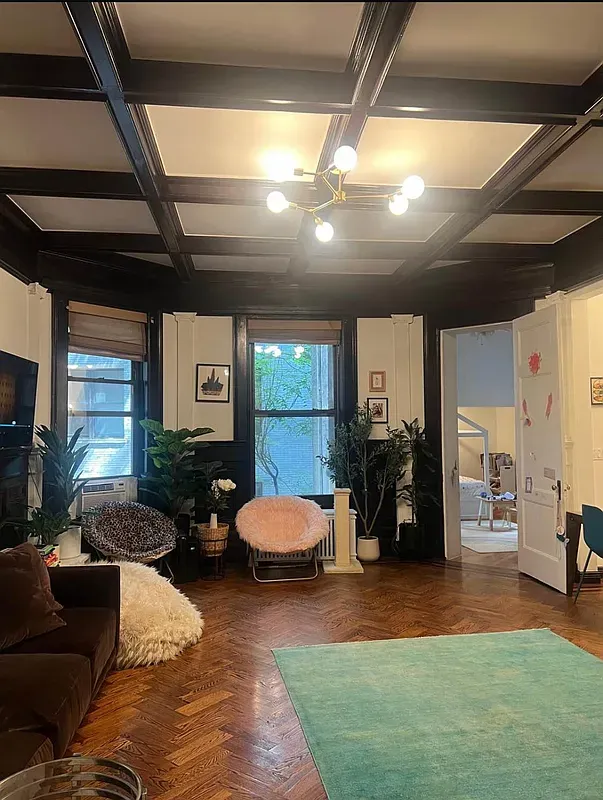 a living room with furniture and gym equipment
