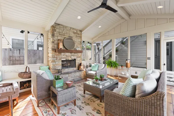 a living room with fireplace furniture and a large window