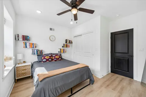 a bedroom with a bed and a chandelier