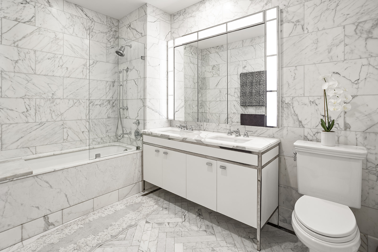 100 Barclay Street, Unit 17J Manhattan, NY 10007 - Photo 6 of 18 a bathroom with a granite countertop sink toilet a mirror and bathtub