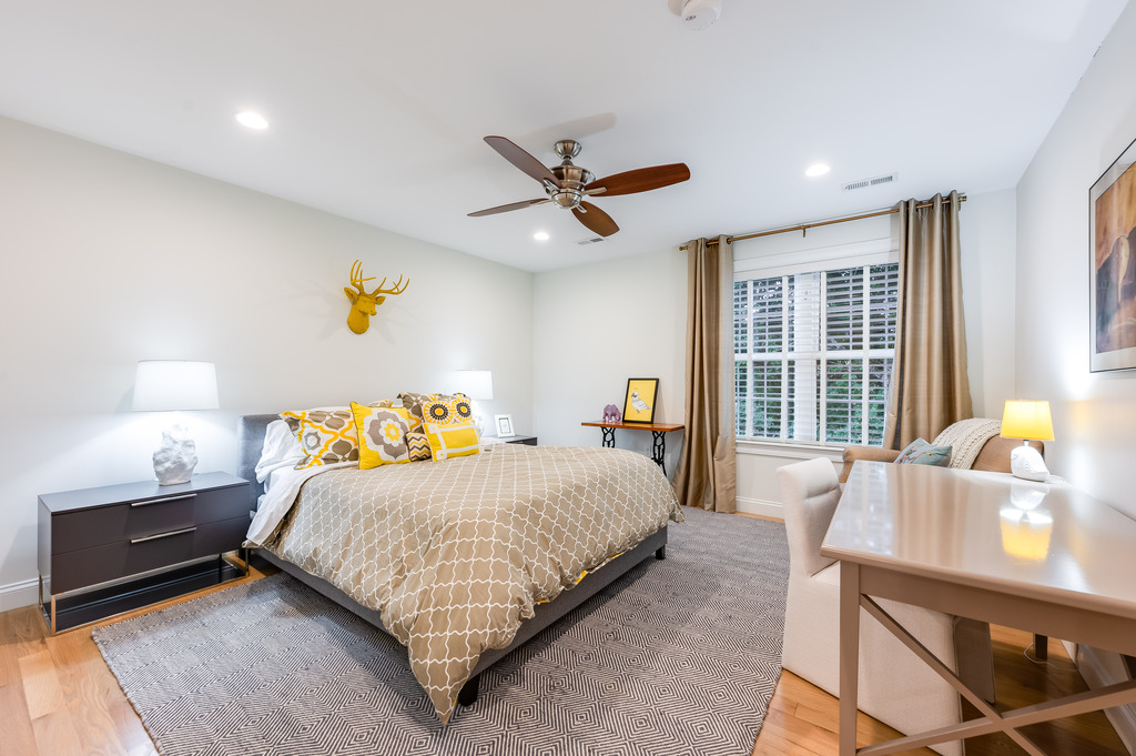 45 Washburn Avenue Needham, MA 02492 - Photo 13 of 23 a bedroom with a bed and wooden floor