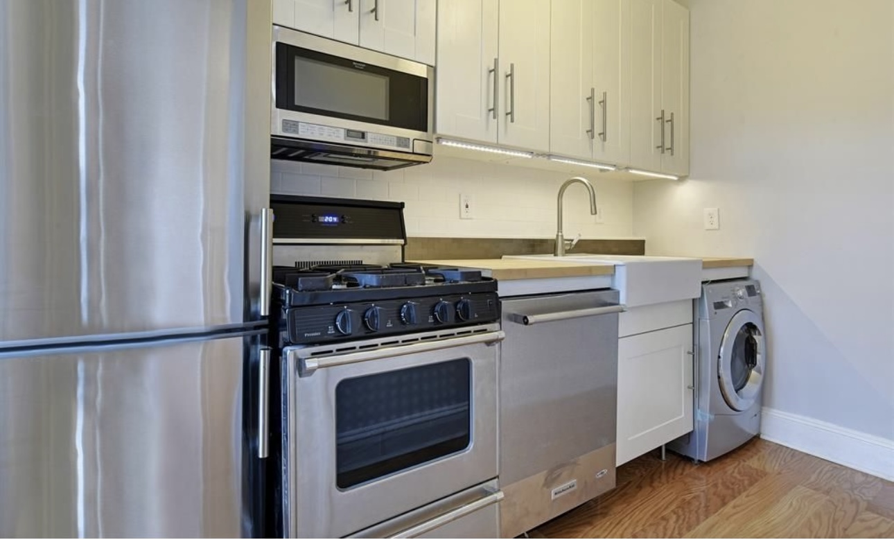 195 Adelphi Street, Unit 3 Brooklyn, NY 11205 - Photo 4 of 7 a kitchen with stove top oven and cabinets