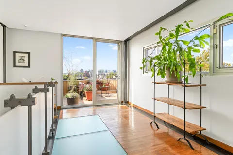 a living room with a floor to ceiling window and floor to ceiling window