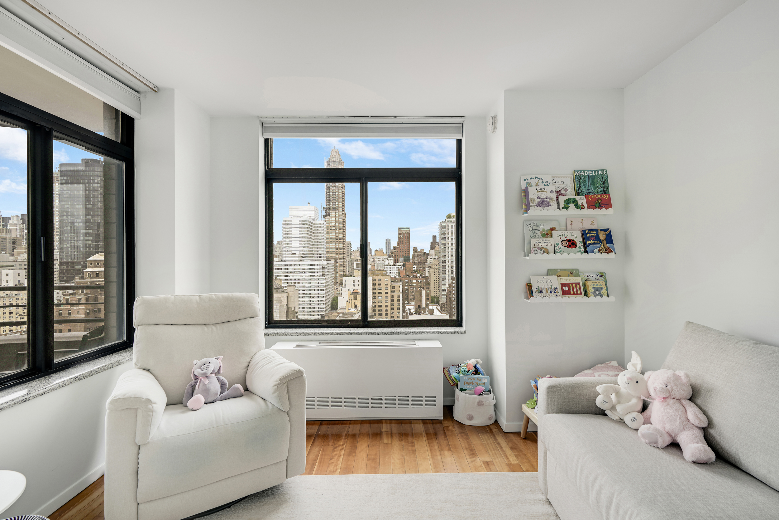 400 East 70th Street, Unit 2402 Manhattan, NY 10021 - Photo 11 of 18 a living room with furniture and a window
