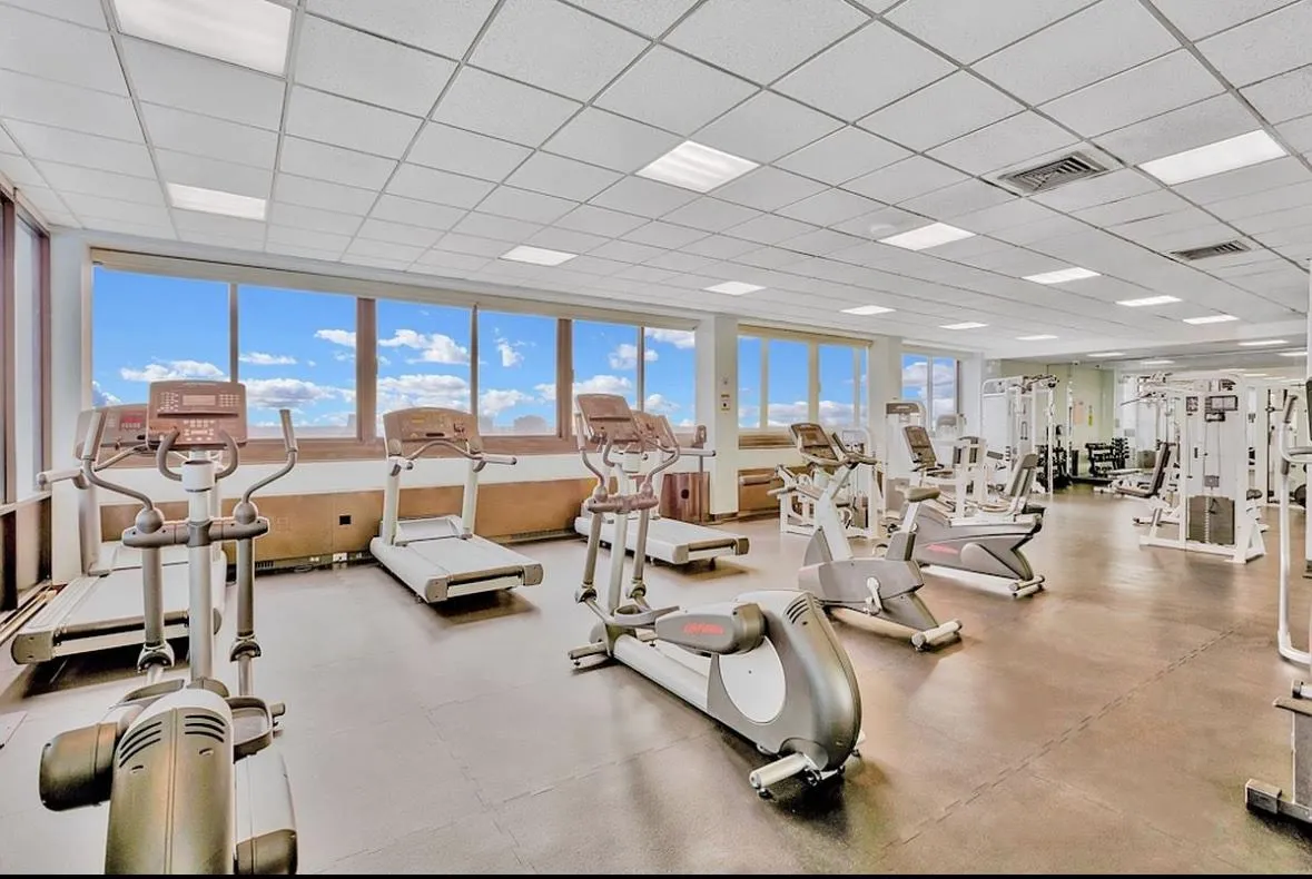 a lots of gym equipment and a table