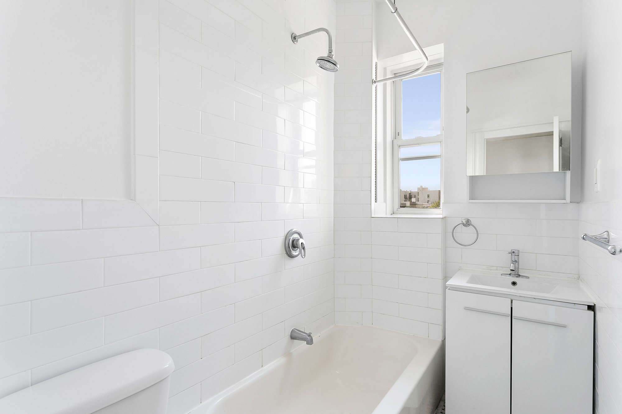 701 Saint Marks Avenue, Unit 3B Brooklyn, NY 11216 - Photo 6 of 7 a bathroom with a bathtub a sink a toilet and a mirror