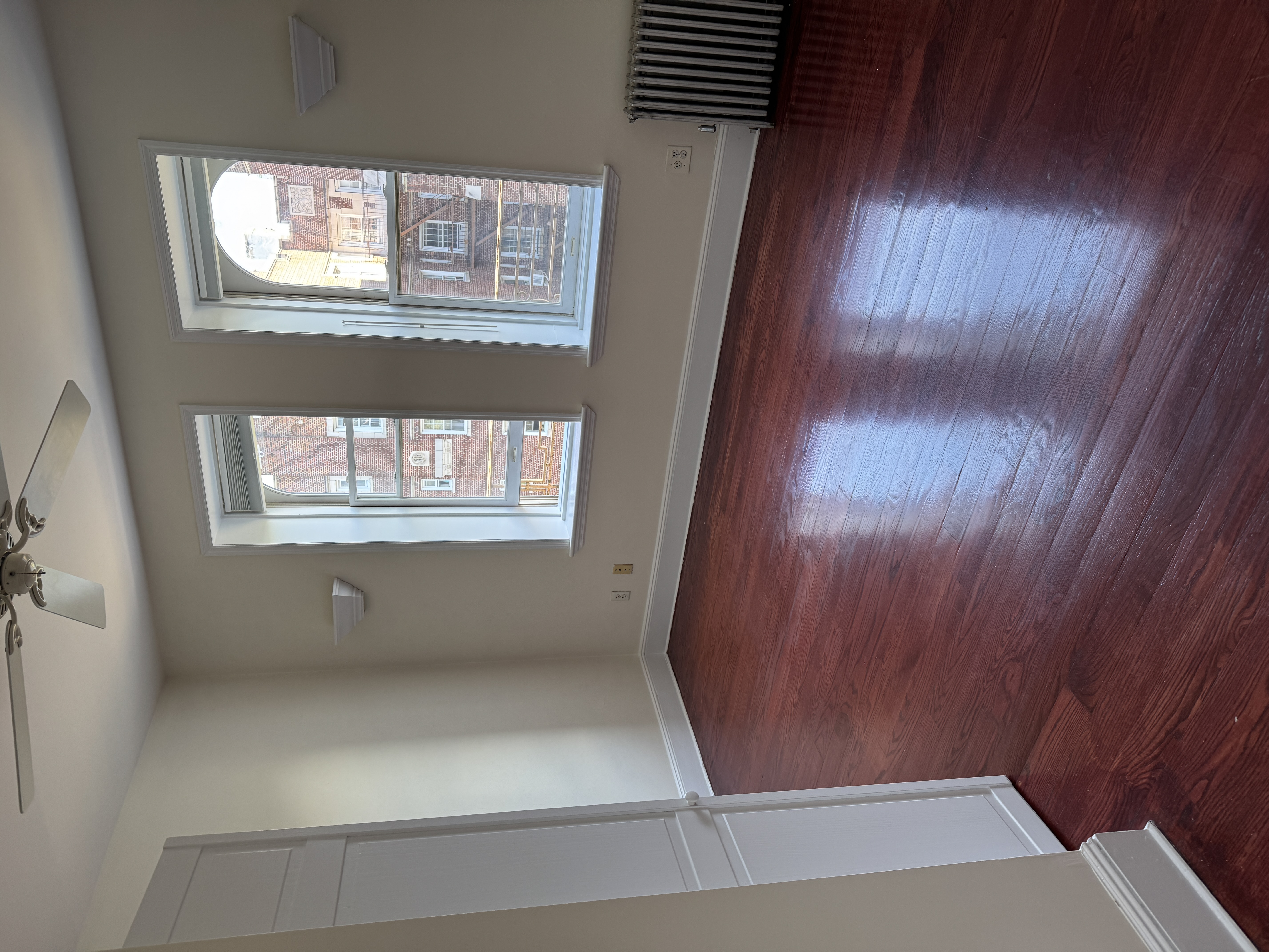 260 Cumberland Street, Unit 21 Brooklyn, NY 11205 - Photo 6 of 13 a view of an empty room with wooden floor and a window